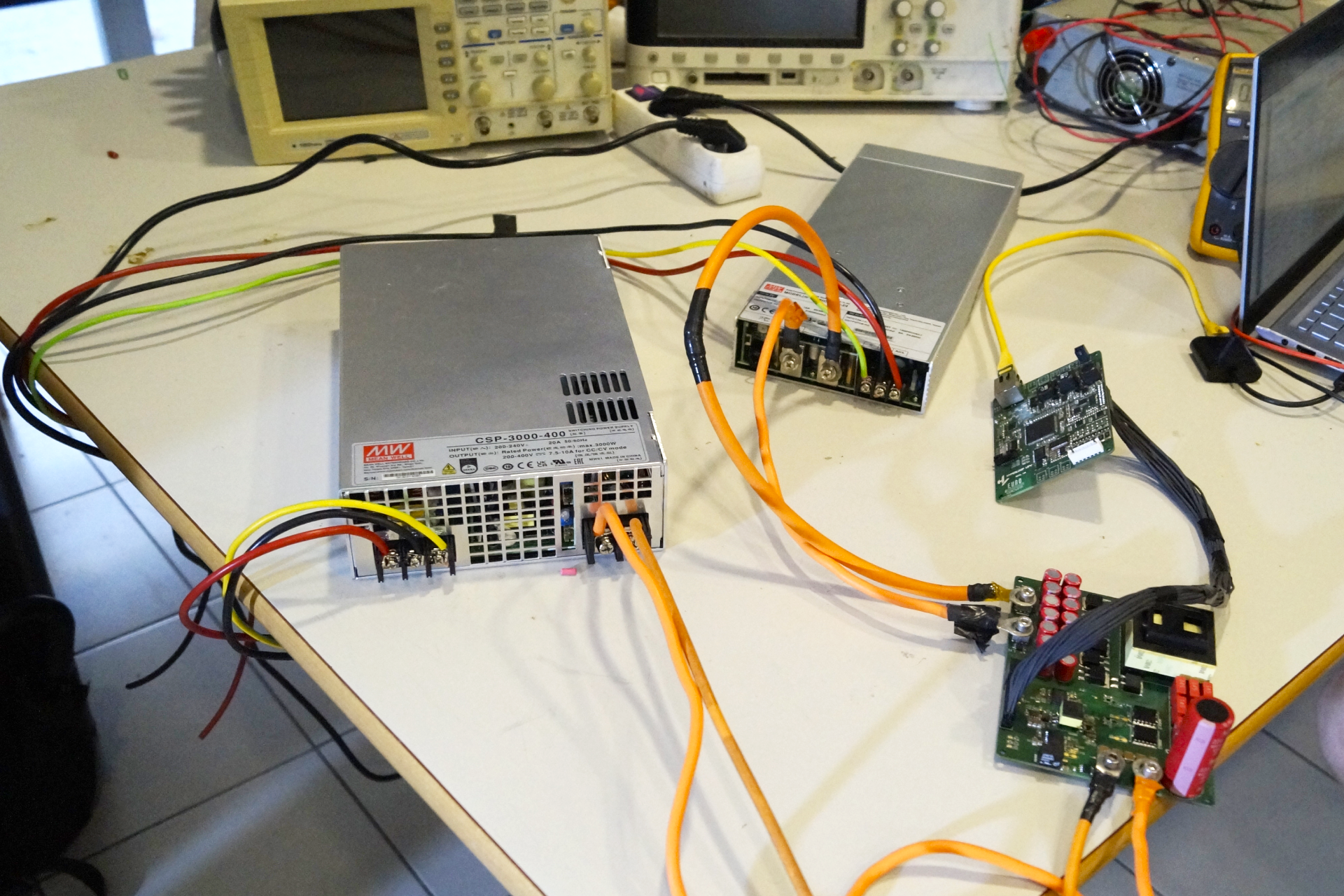 MEAN WELL power supply connected to Hyperloop UPV's custom open-frame PCB with visible wiring, highlighting collaborative engineering in power and control integration.